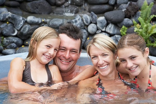 Happy family enjoying hot tub